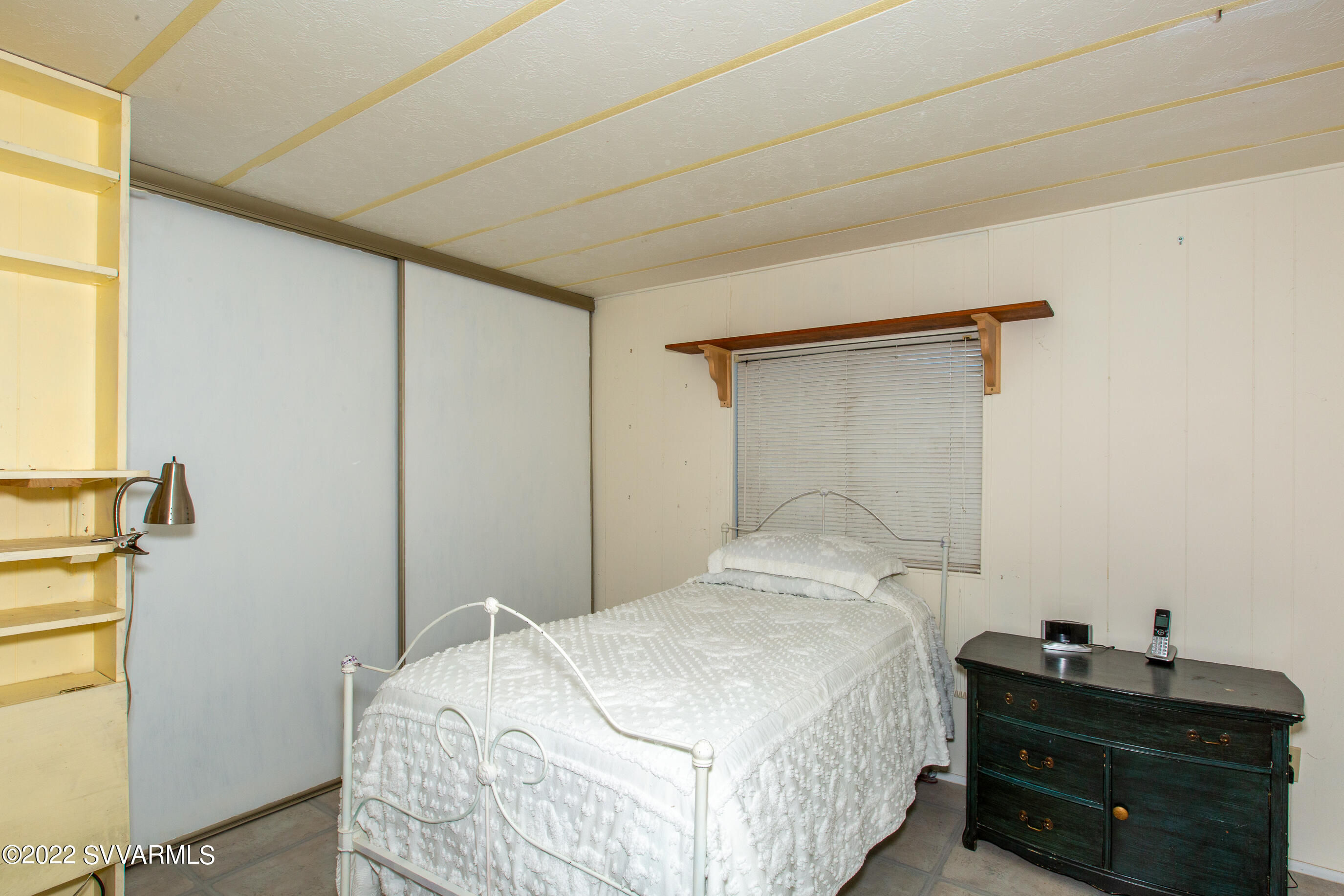 3765 East Valley Vista Road Rimrock, AZ 86335 - Photo 14 of 20 a bedroom with a bed and a window