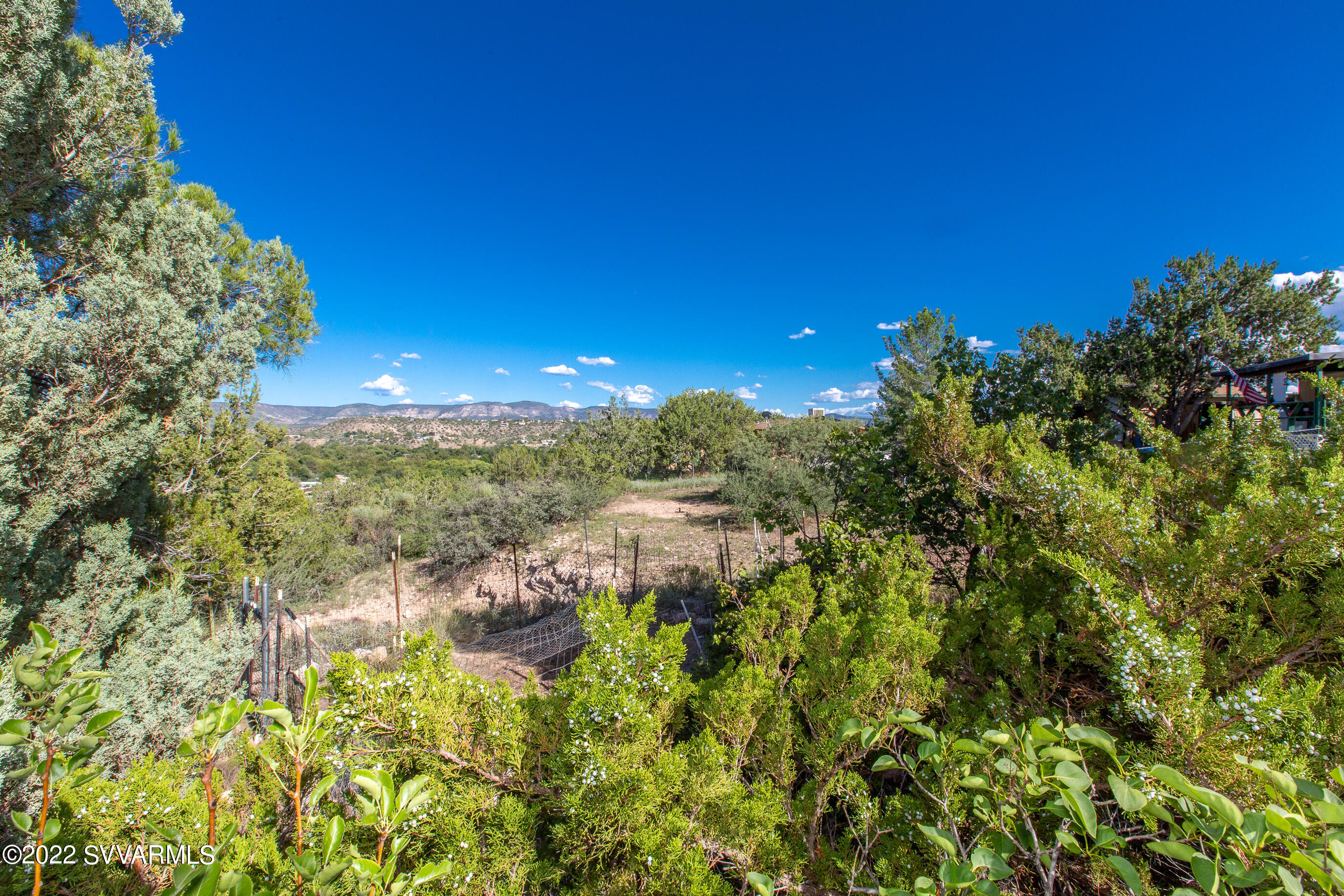 3765 East Valley Vista Road Rimrock, AZ 86335 - Photo 19 of 20 a view of a lake with a house in a yard