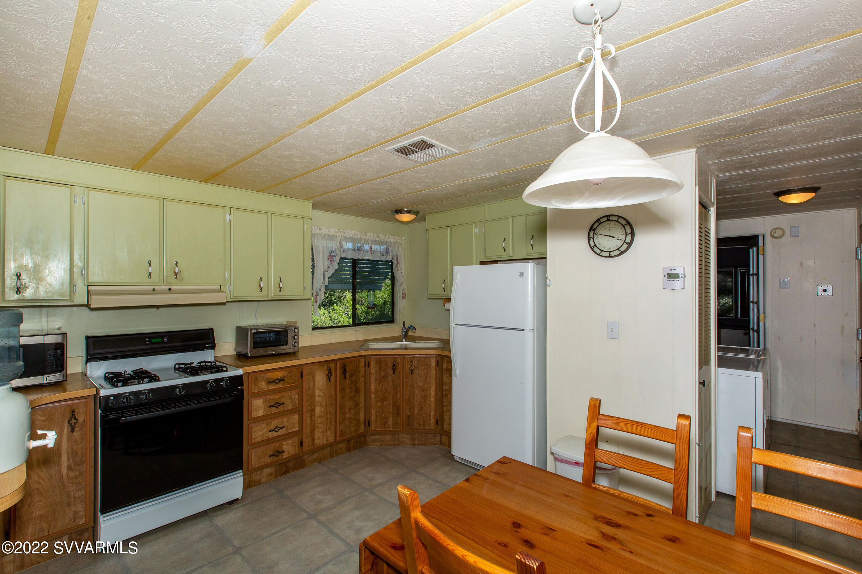 3765 East Valley Vista Road Rimrock, AZ 86335 - Photo 8 of 20 a kitchen with stainless steel appliances a stove a refrigerator and cabinets