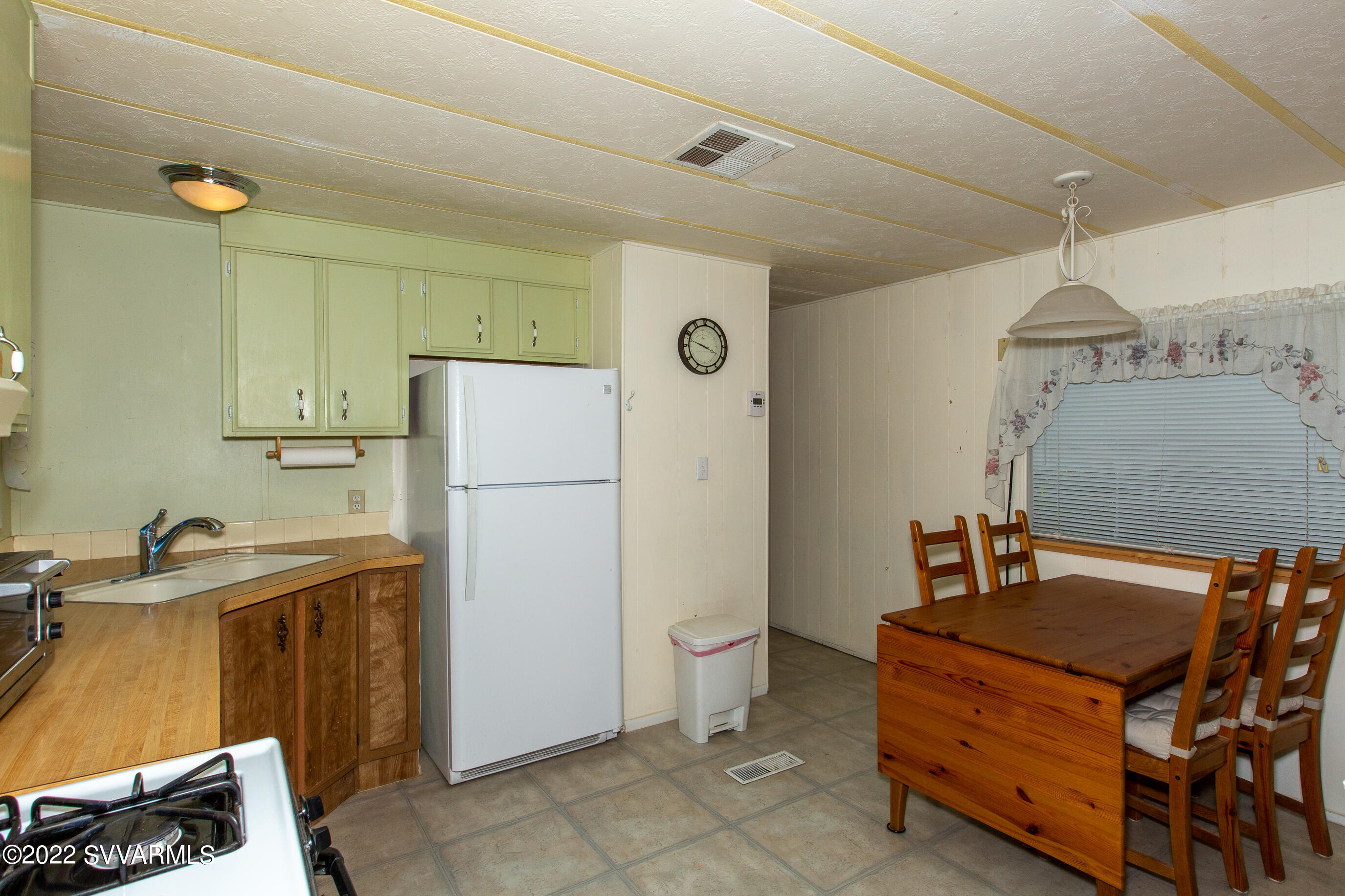 3765 East Valley Vista Road Rimrock, AZ 86335 - Photo 9 of 20 a kitchen with a refrigerator and a stove