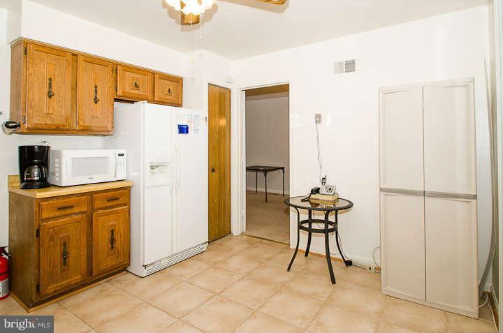 6915 Rochambeau Place Springfield, VA 22153 - Photo 8 of 23 a kitchen with stainless steel appliances a refrigerator and cabinets