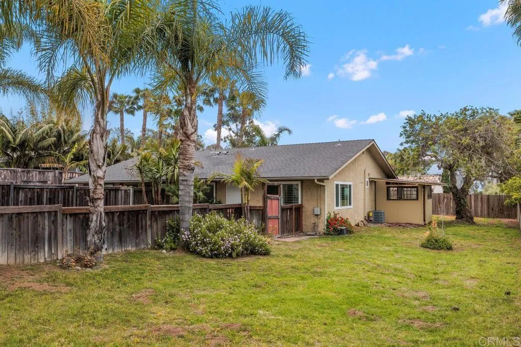 889 Bracero Road Encinitas, CA 92024 - Photo 2 of 59 a view of a house with a small yard and palm trees