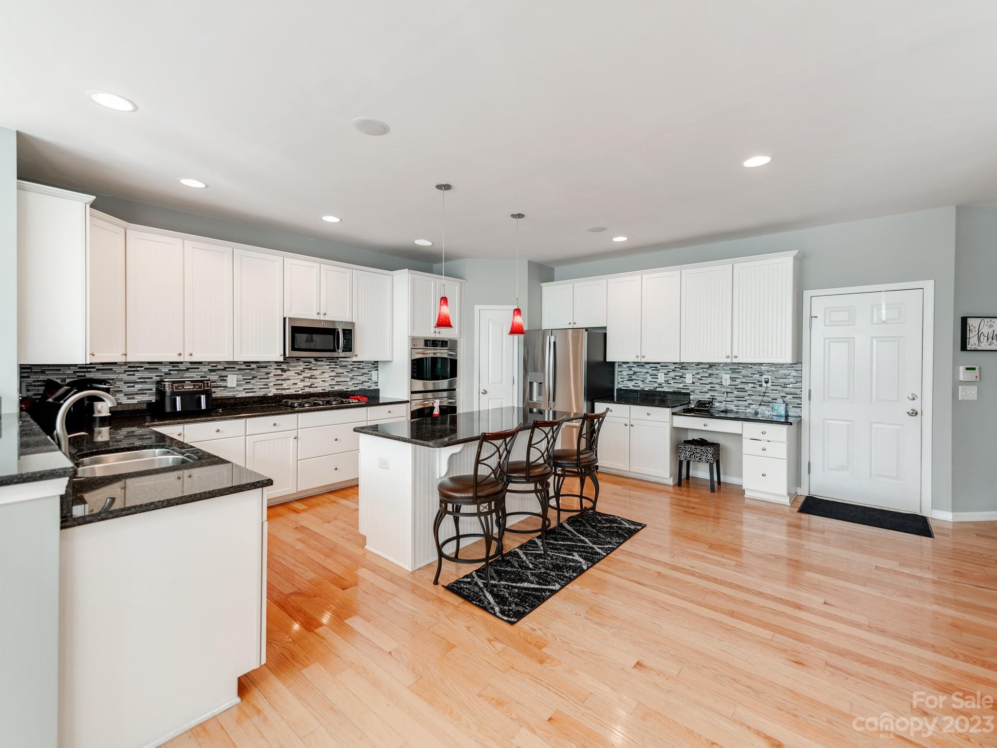 1603 Randwick Way Matthews, NC 28104 - Photo 18 of 48 a kitchen with stainless steel appliances a refrigerator sink and white cabinets