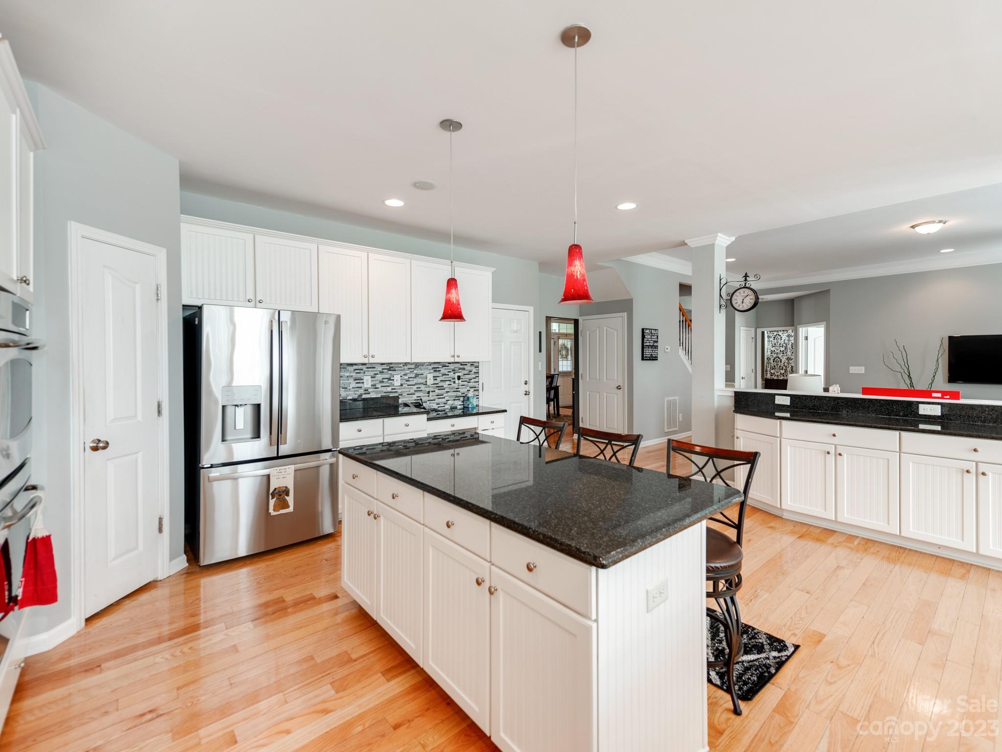 1603 Randwick Way Matthews, NC 28104 - Photo 20 of 48 a kitchen with granite countertop a refrigerator and a stove top oven