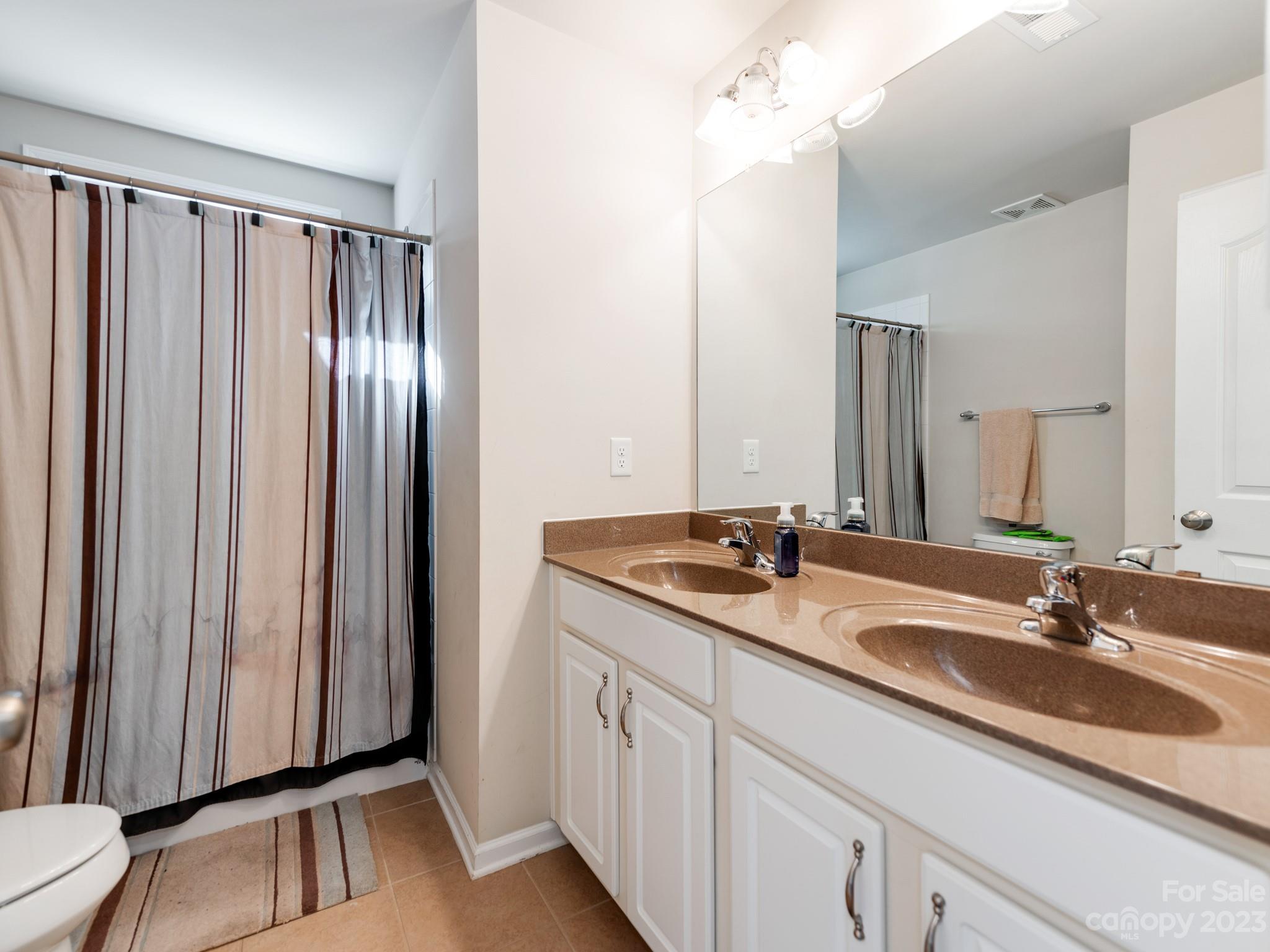 1603 Randwick Way Matthews, NC 28104 - Photo 40 of 48 a bathroom with a double vanity sink and a mirror