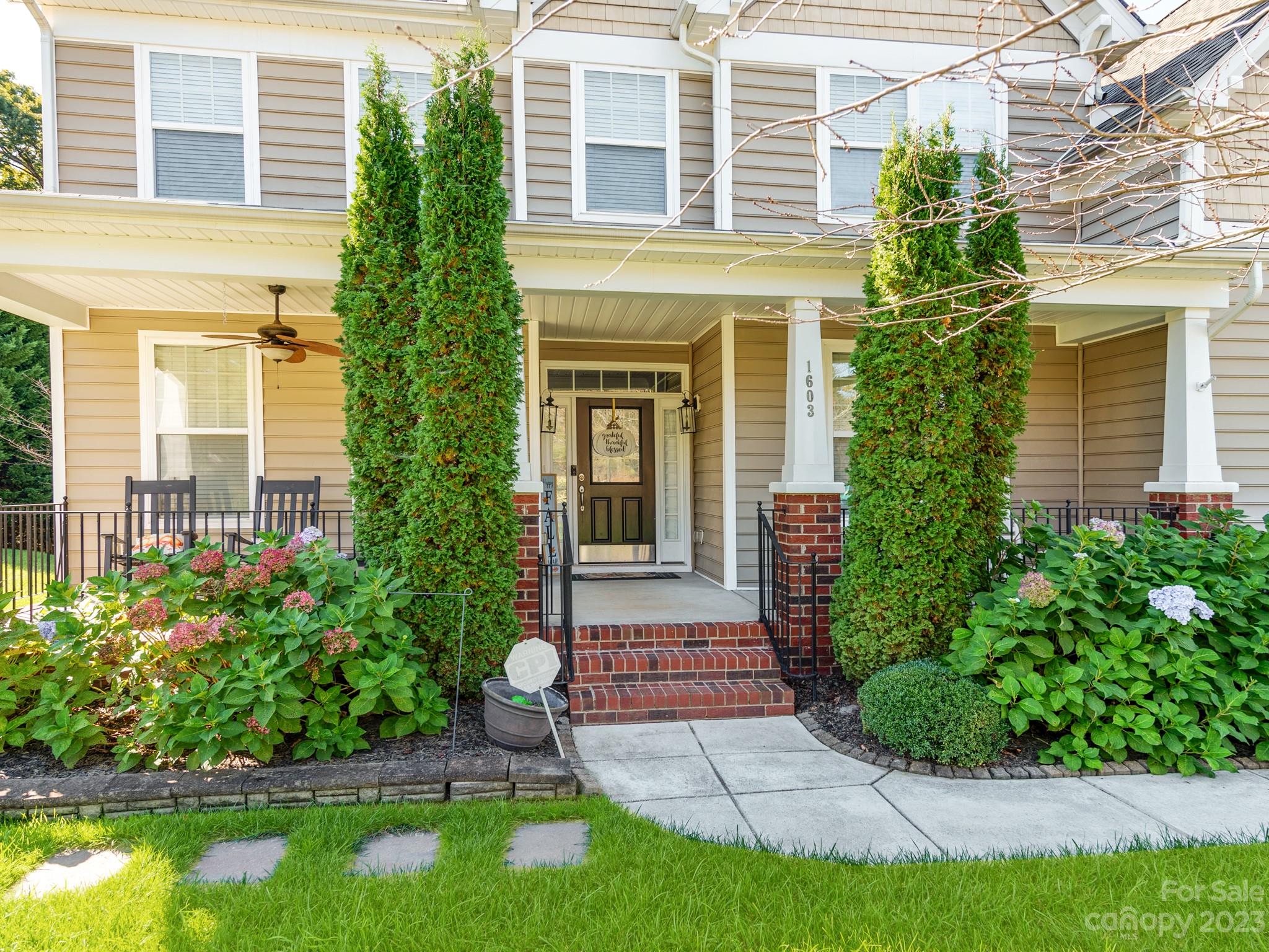 1603 Randwick Way Matthews, NC 28104 - Photo 5 of 48 a front view of a house with a yard and potted plants