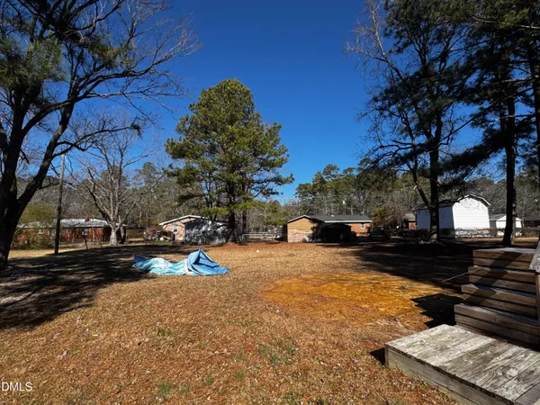 a view of a yard with snow on the road