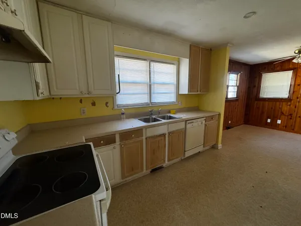 a kitchen that has a sink and a stove in it