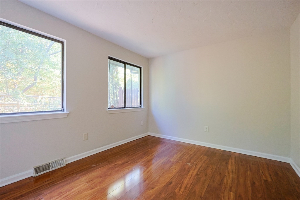 63 Trailside Way, Unit 63 Ashland, MA 01721 - Photo 15 of 39 a view of a room with wooden floor and windows