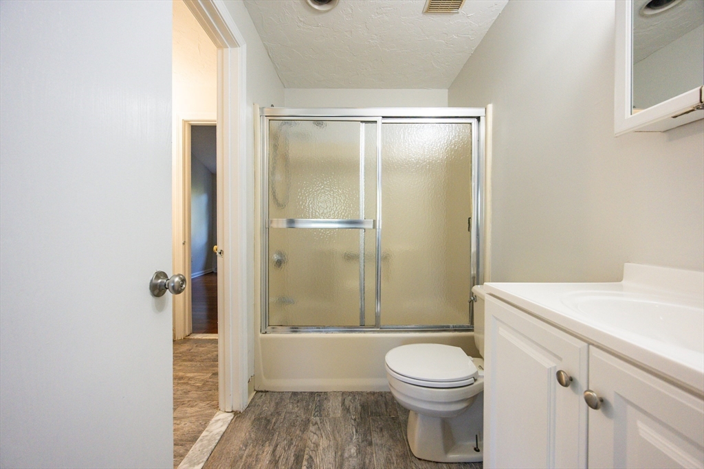 63 Trailside Way, Unit 63 Ashland, MA 01721 - Photo 17 of 39 a bathroom with a sink a toilet a mirror and shower