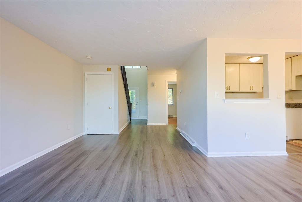 63 Trailside Way, Unit 63 Ashland, MA 01721 - Photo 5 of 39 a view of a hallway with wooden floor