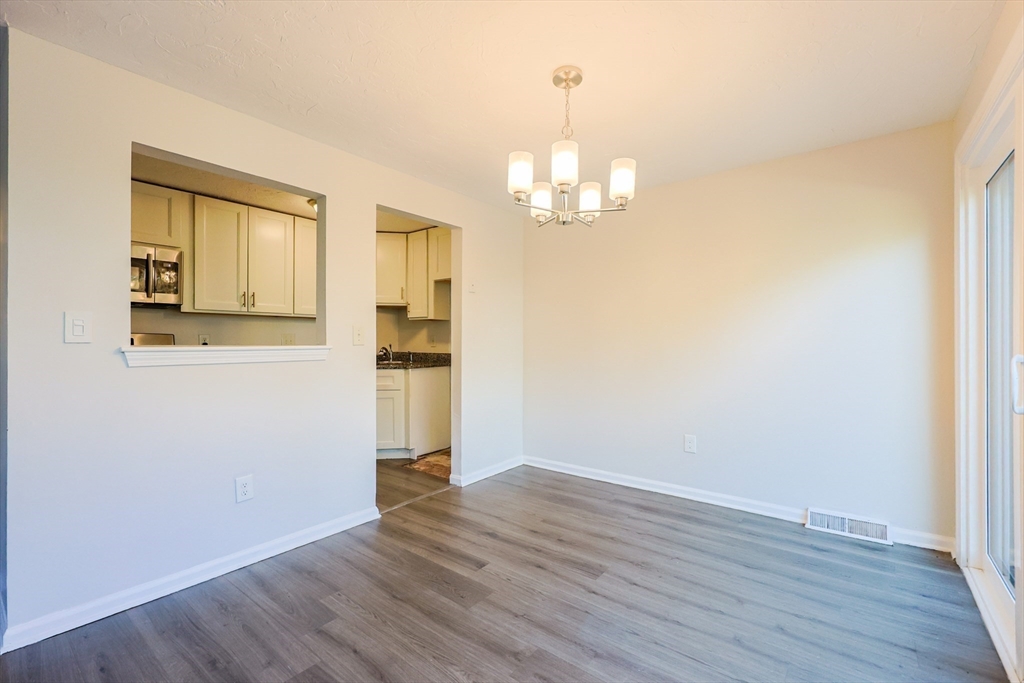63 Trailside Way, Unit 63 Ashland, MA 01721 - Photo 8 of 39 a view of empty room with wooden floor
