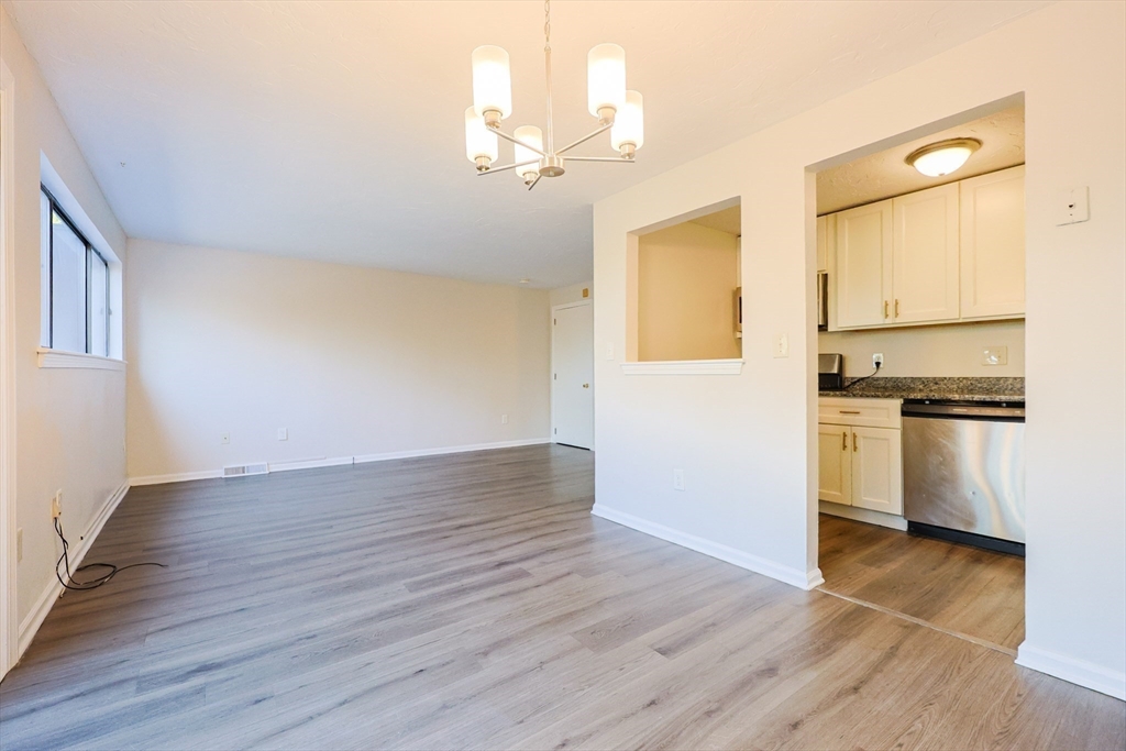 63 Trailside Way, Unit 63 Ashland, MA 01721 - Photo 9 of 39 a view of kitchen with wooden floor electronic appliances and cabinets