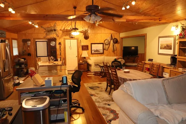 a view of house with tall trees