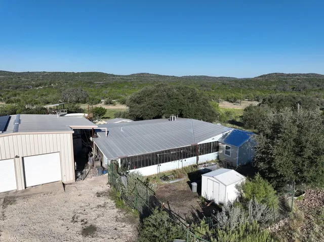 an aerial view of residential houses with outdoor space