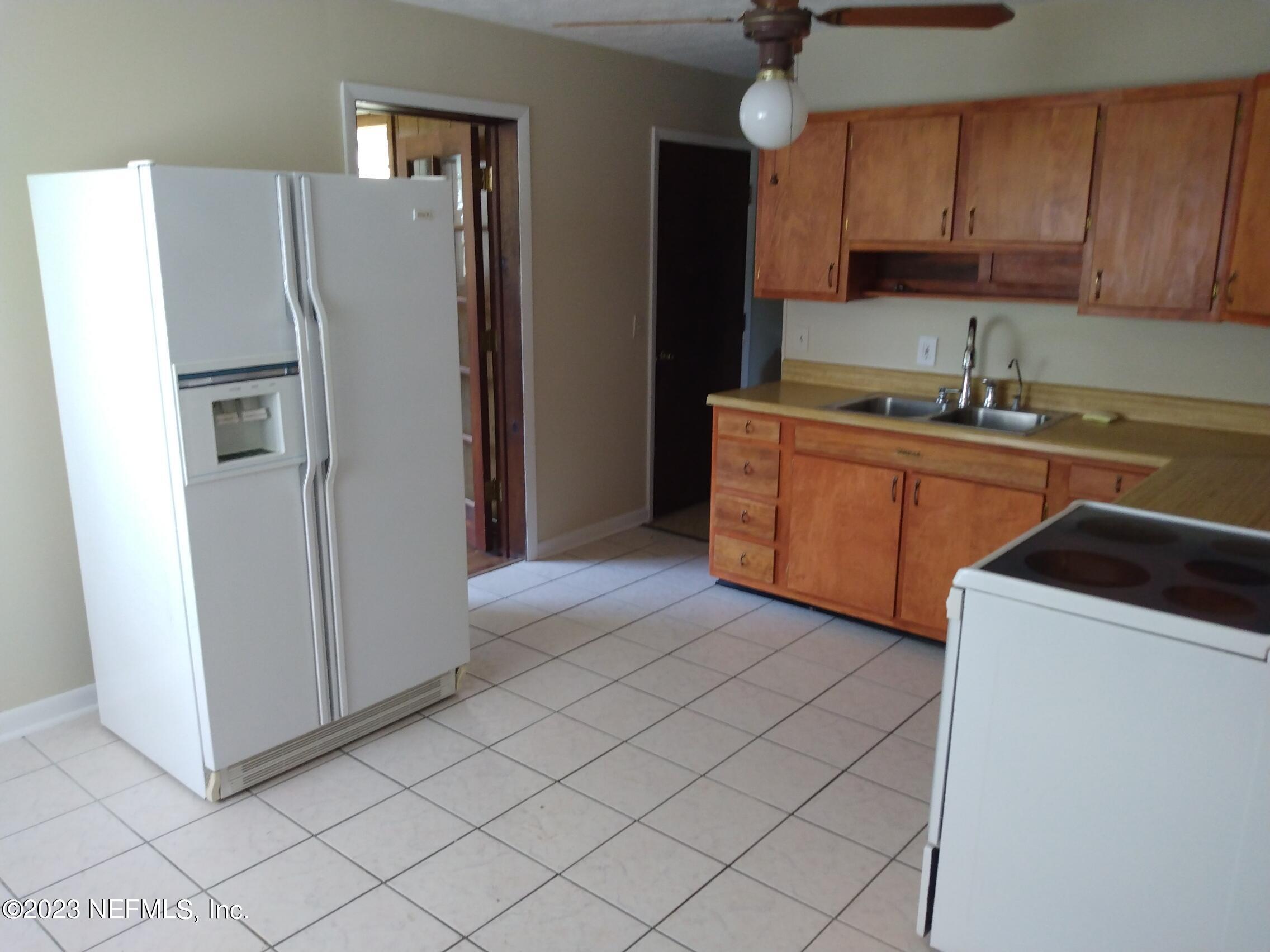 710 Redfin Drive Atlantic Beach, FL 32233 - Photo 16 of 38 a kitchen with stainless steel appliances granite countertop a refrigerator and a sink