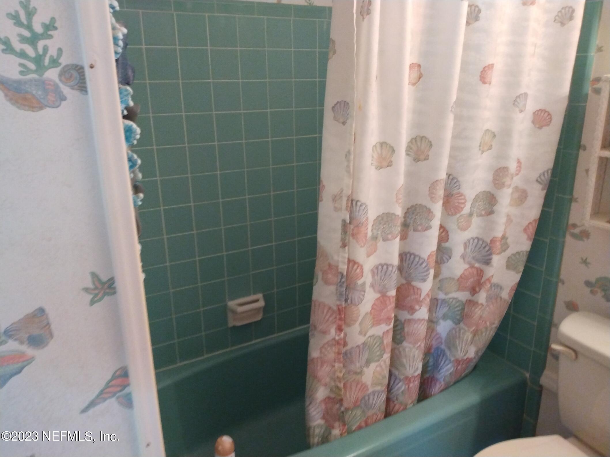 710 Redfin Drive Atlantic Beach, FL 32233 - Photo 18 of 38 a bathroom with a toilet and shower