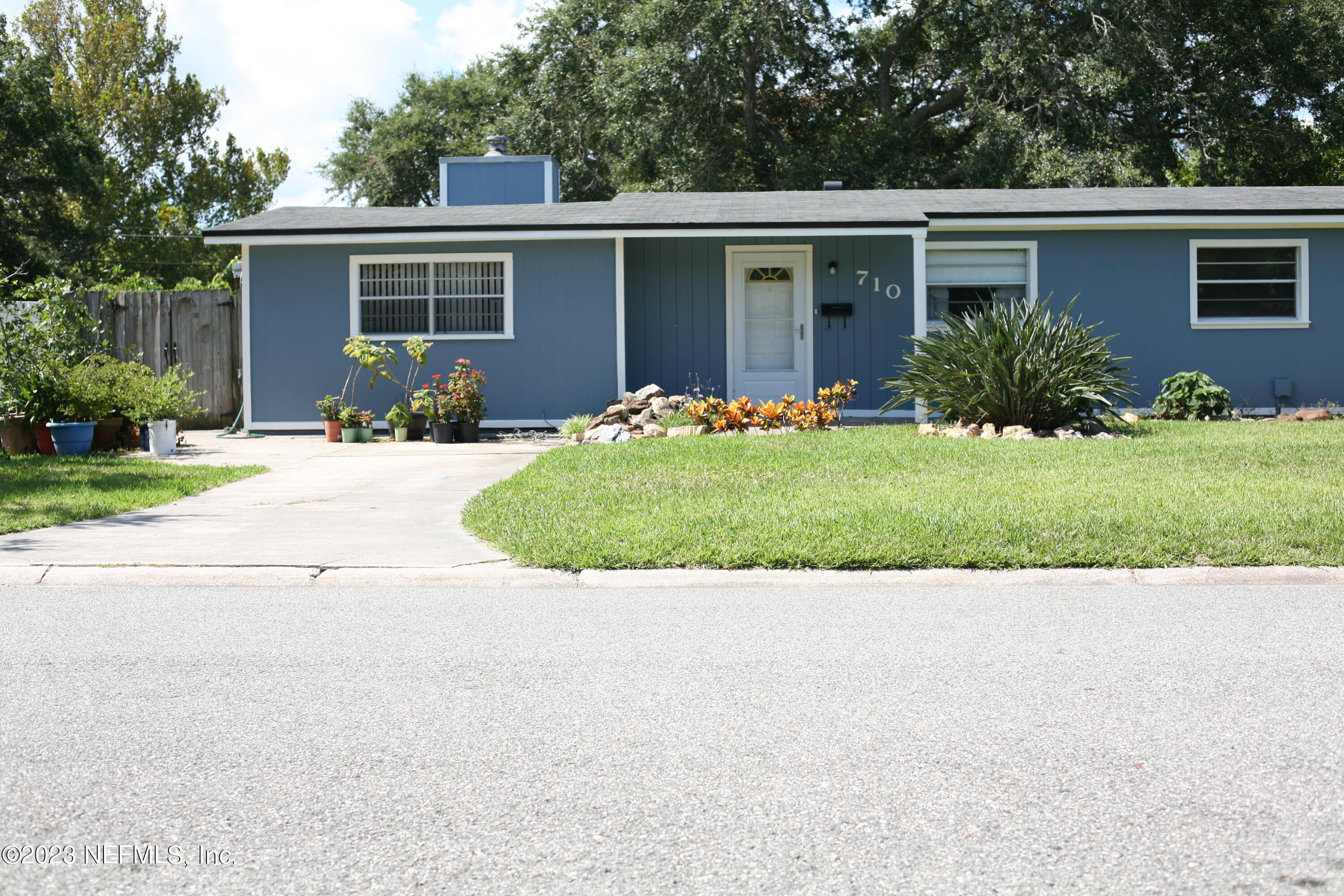 710 Redfin Drive Atlantic Beach, FL 32233 - Photo 2 of 38 front view of house with a yard and potted plants
