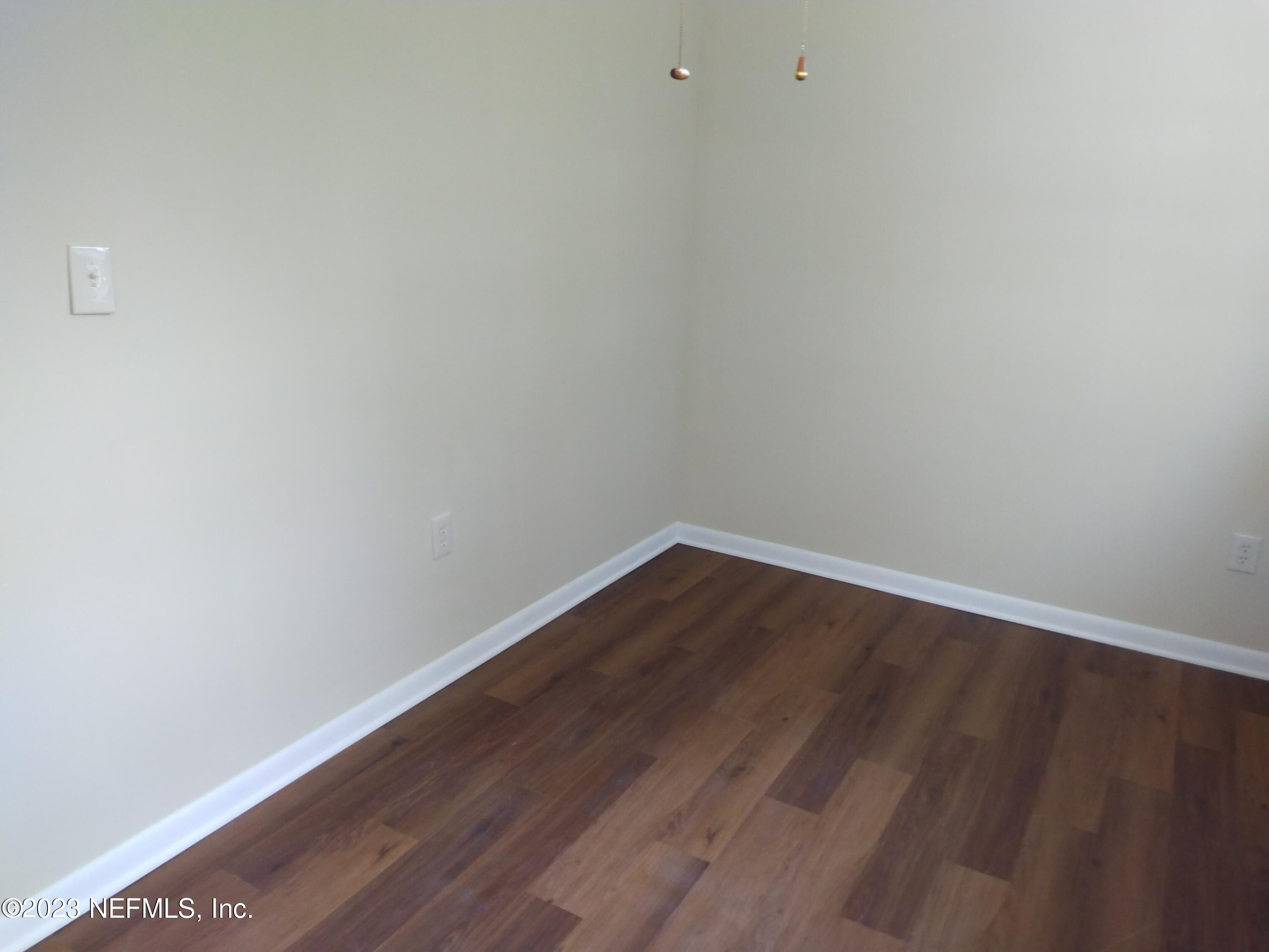 710 Redfin Drive Atlantic Beach, FL 32233 - Photo 26 of 38 a view of an empty room with wooden floor