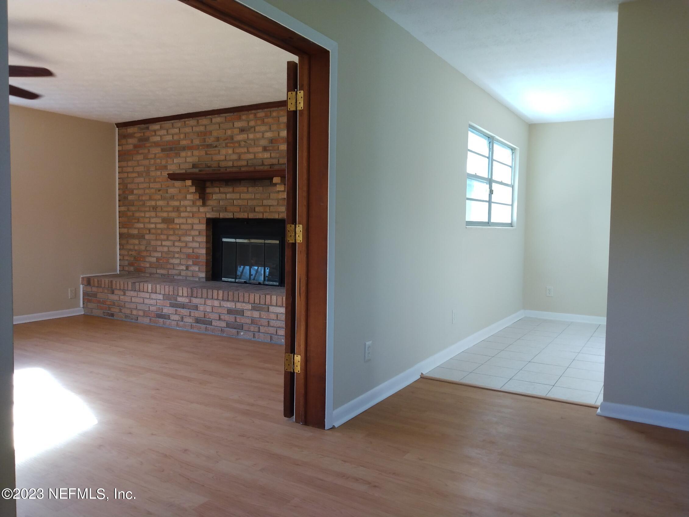 710 Redfin Drive Atlantic Beach, FL 32233 - Photo 5 of 38 a view of empty room with wooden floor and fireplace
