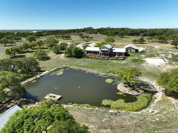 an aerial view of a house with a lake view