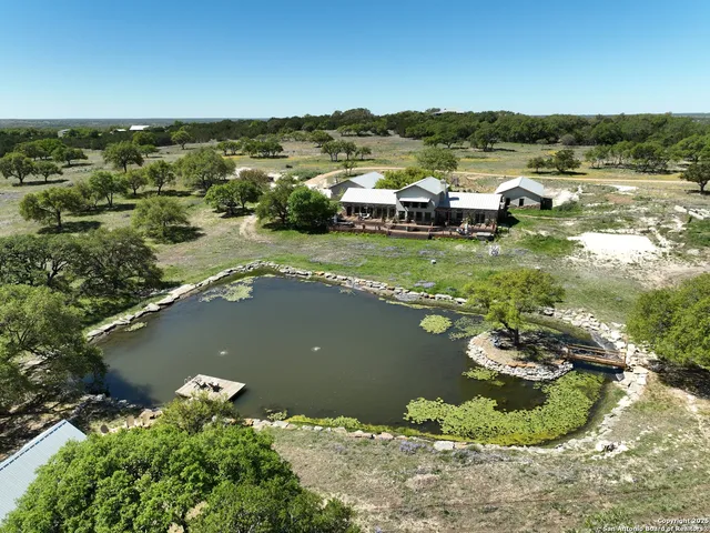 an aerial view of a house with a lake view