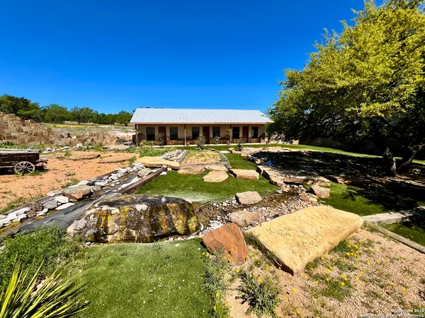 a view of a swimming pool with lawn chairs under an umbrella