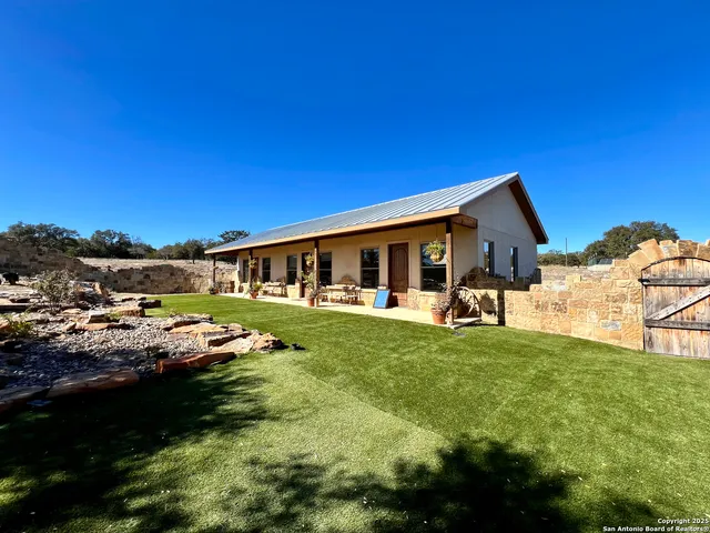 a view of a house with backyard porch and furniture