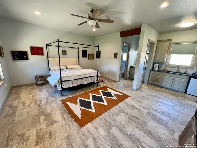 a bedroom with a bed and a view of living room