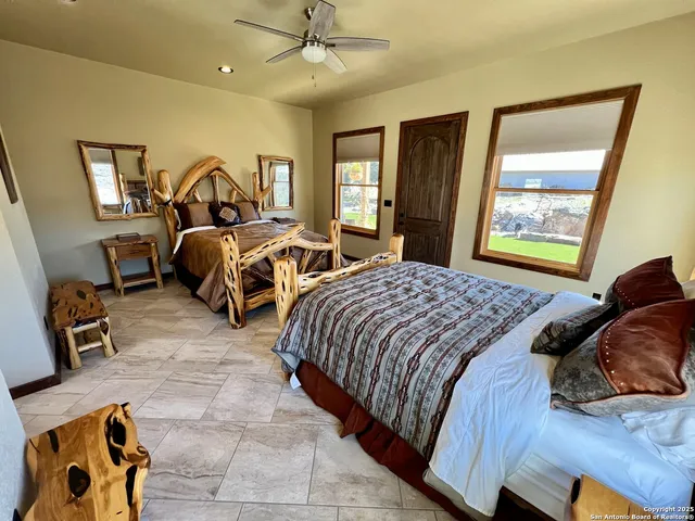 a bedroom with two beds and a window