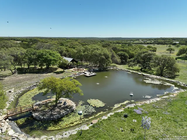 an aerial view of a houses with yard