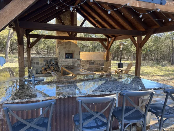 a view of a dining table and chairs in the patio