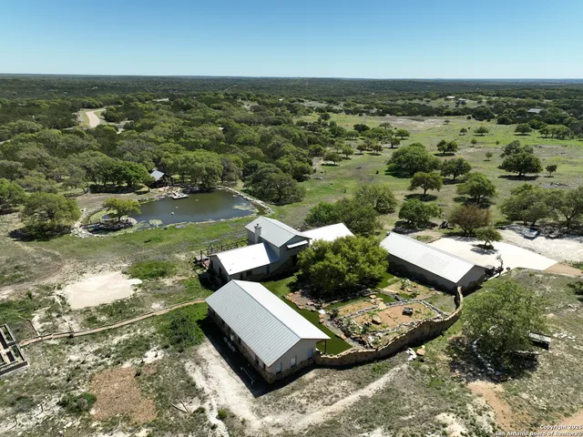 an aerial view of a house with a yard