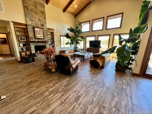 a living room with fireplace furniture and a flat screen tv