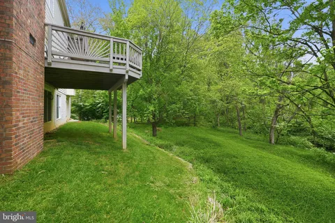 a view of deck with furniture and trees