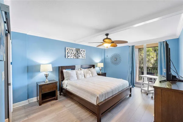 a bedroom with a bed a dresser next to a window