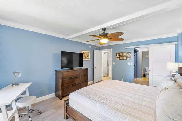 a bedroom with a bed and a flat screen tv