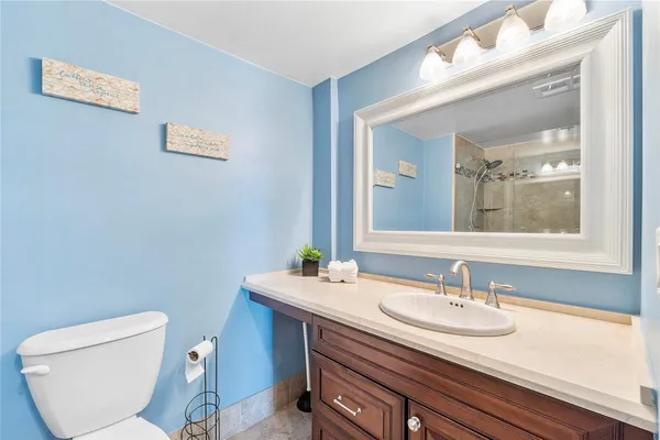 a bathroom with a toilet sink and mirror