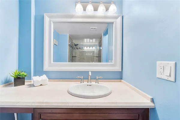 a bathroom with a sink and a mirror