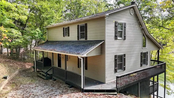 a view of a house with a yard chairs and table