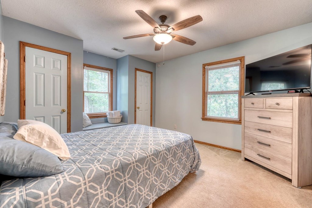 3739 Pat Colwell Road Blairsville, GA 30512 - Photo 27 of 55 a bedroom with a large bed and a flat tv screen on dresser