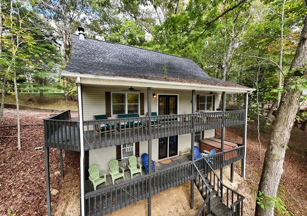 a view of a house with backyard and sitting area