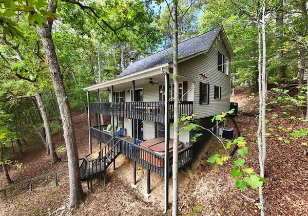 a view of a house with backyard and sitting area