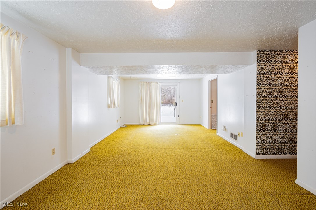 5905 Renninger Road New Franklin, OH 44319 - Photo 20 of 31 Carpeted empty room featuring a textured ceiling