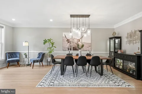 a living room with lots of furniture a rug and a painting on the wall