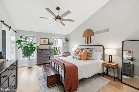 a bedroom with a bed and a potted plant