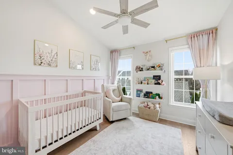 a bedroom with furniture and a large window