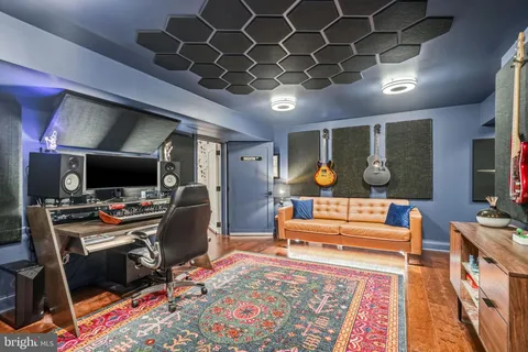 a bedroom with furniture and a flat screen tv