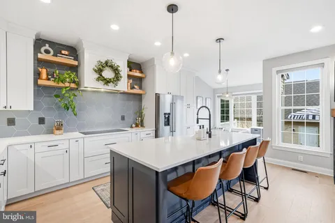 a kitchen with a table chairs sink and cabinets