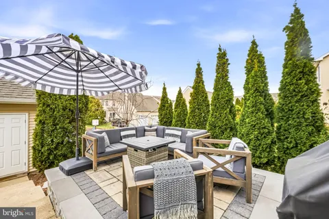 a view of a patio with table and chairs potted plants with sky view